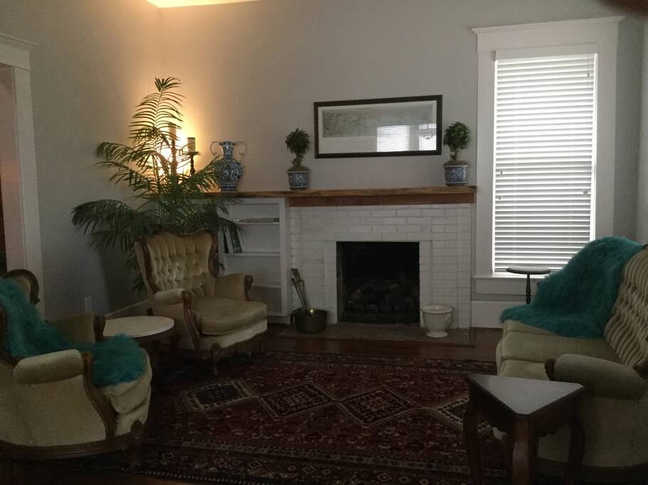 Living room. Original fireplace and hearth, with Texas live-edged cedar mantle.