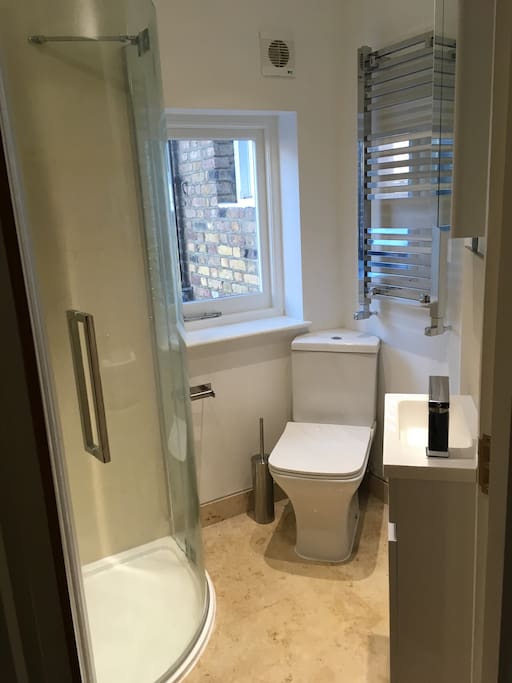 lovely bathroom with rainfall shower cabin, heated towel rail