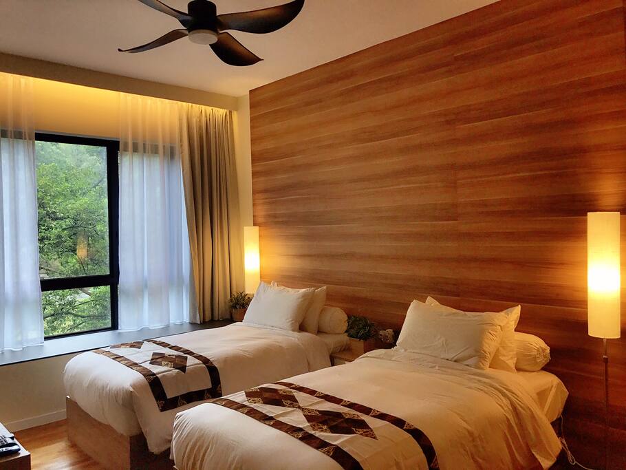 The Twin Room (private) with huge bay window overlooking green sanctuary.
