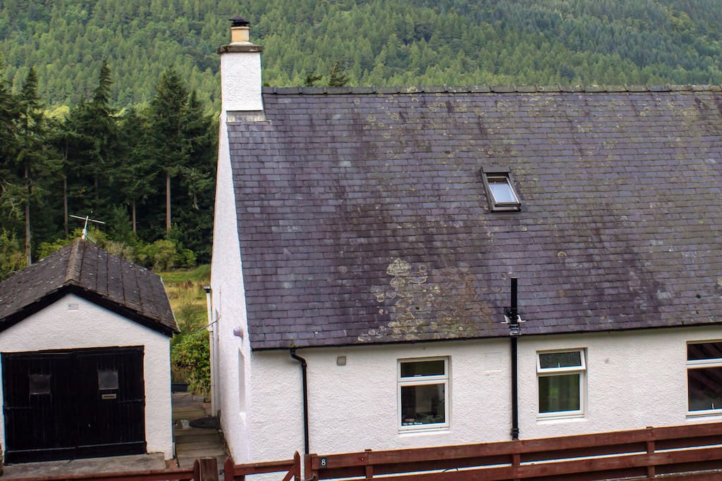 View of the house and distant woodlands from shared access road.