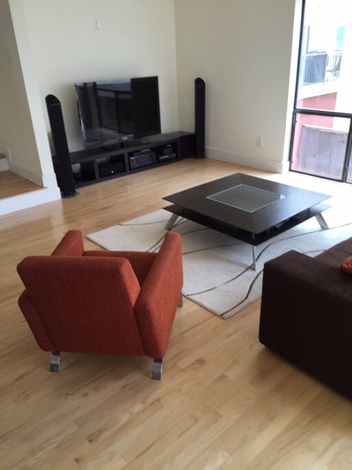 Living room area with giant windows & entertainment system