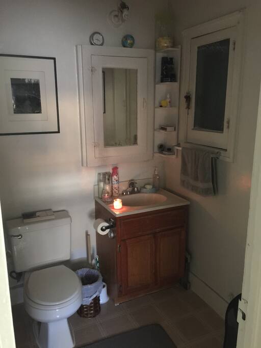 Bathroom, tub and shower head to the left of this pic