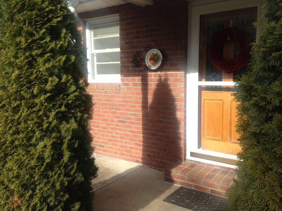 Walkway leading into pathway that curves left to lead to the apartment entrance down below.