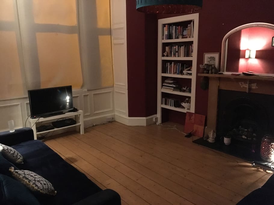 Livingroom in the evening, traditional fireplace and Edinburgh Press