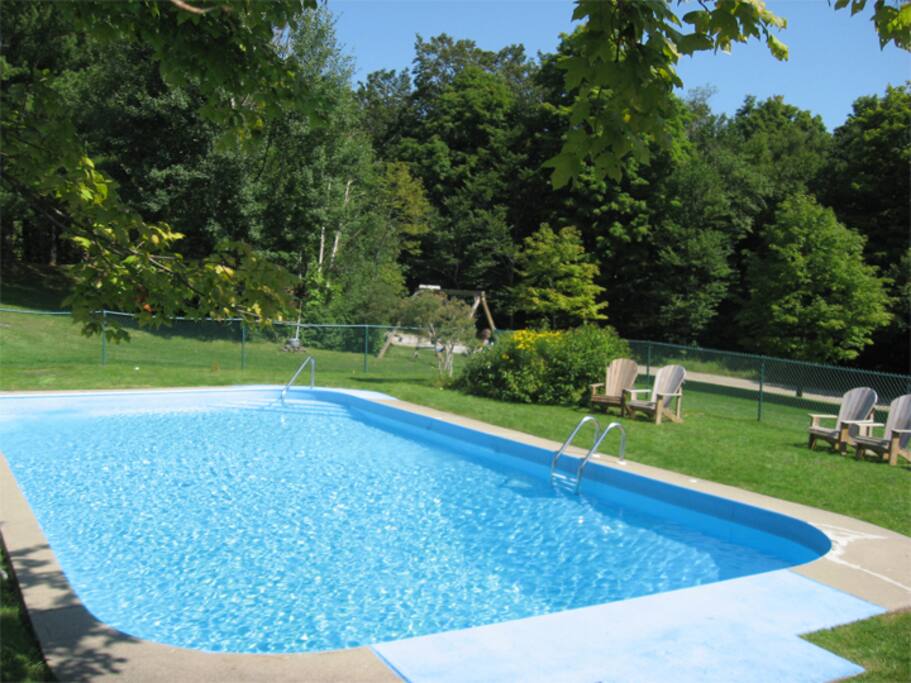 The building's communal outdoor pool - open during the summer months. One of a very few buildings in the area with an outdoor pool! Grills for BBQs and an outdoor fire pit are close by. The pool is just a few feet from our private patio.