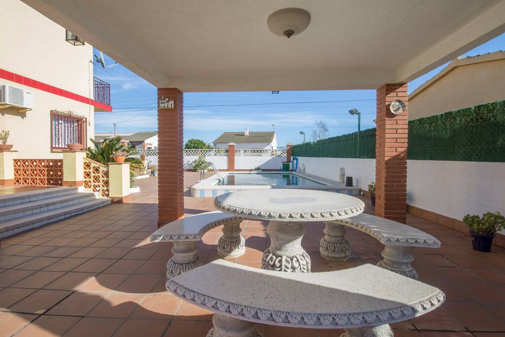 Outside stone seating area with original sun feature and stone table
