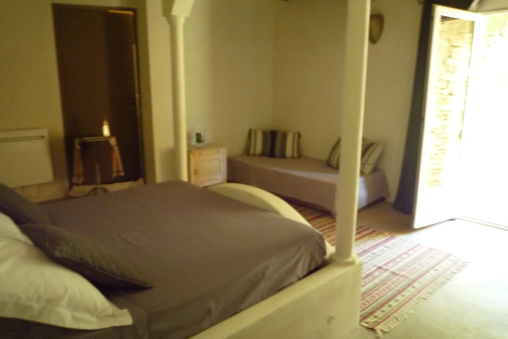 chambre avec un grand lit et un lit d'une personne