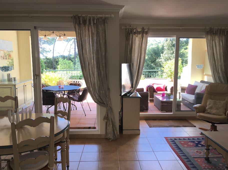 Living room and large terrace with view over mountains and golf course