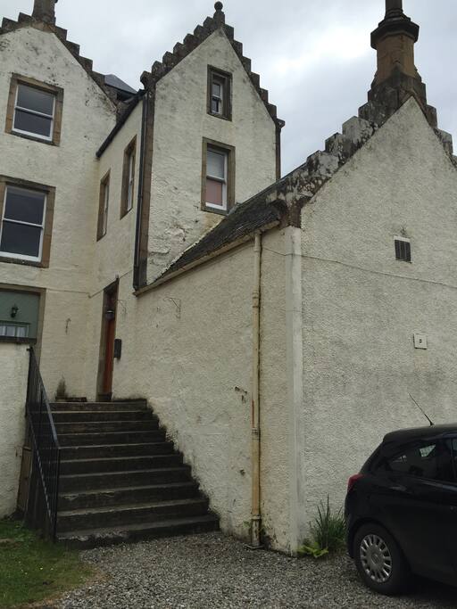 Your entrance is the door to the right at the top of these stairs.