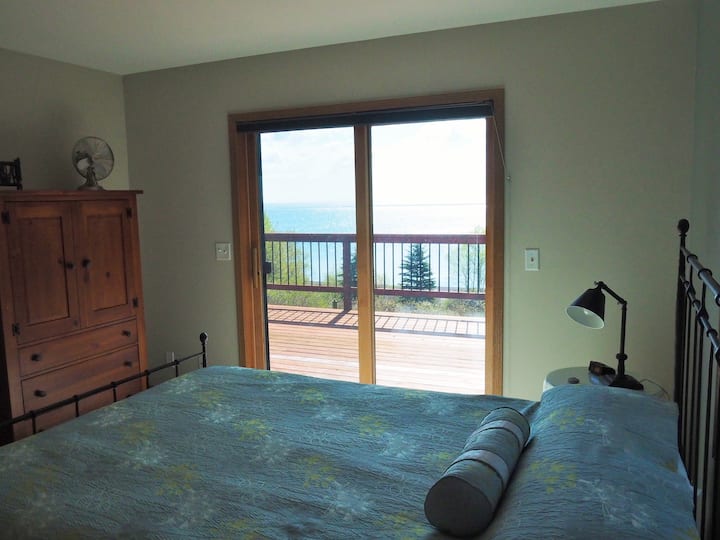 2nd bedroom with sliding door to the deck and views of the lake