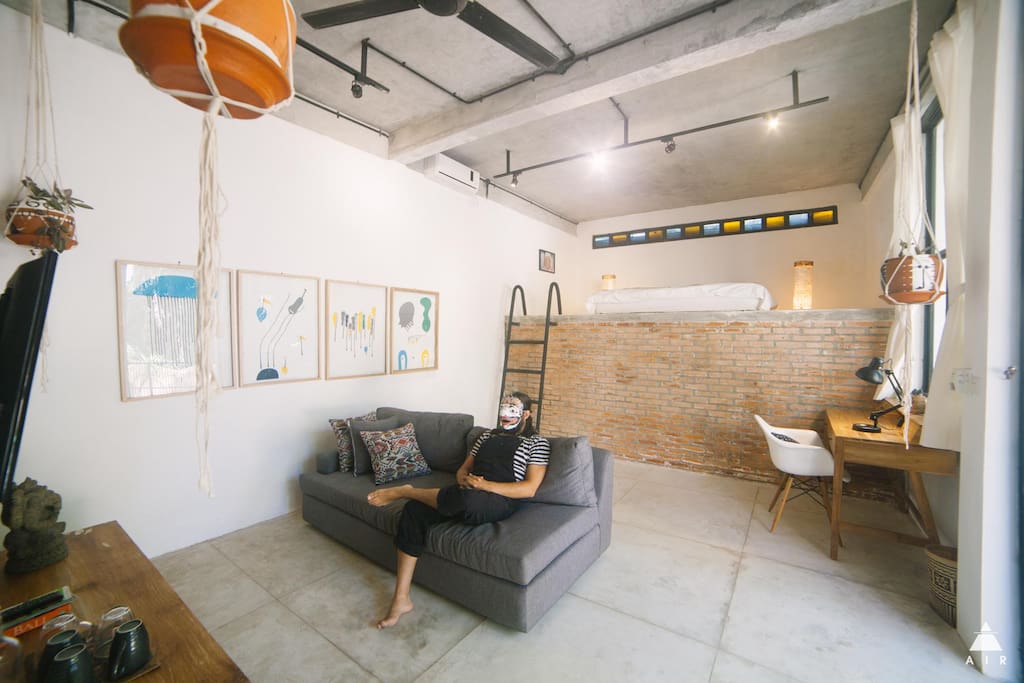 The room is super spacious and has a couch with a media center and selected films about art and Bali