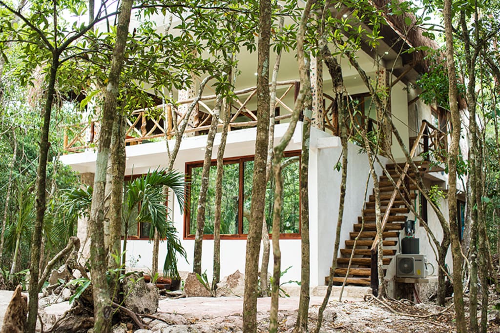 Frontal view of the house, sorounded with beautifull trees