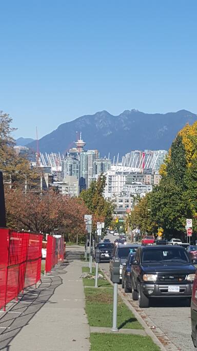 View of city skyline and north shore mountains from the corner of 12th and Yukon