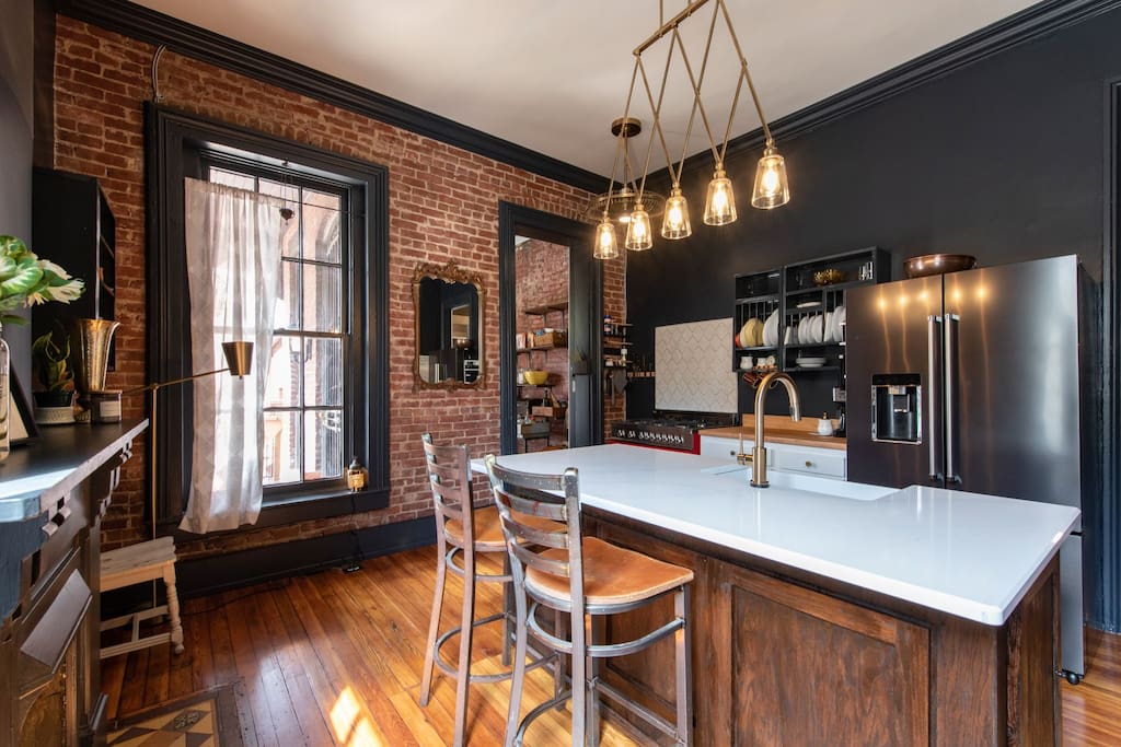The kitchen was redone in summer '18 and features original hardwood floors and a custom island
