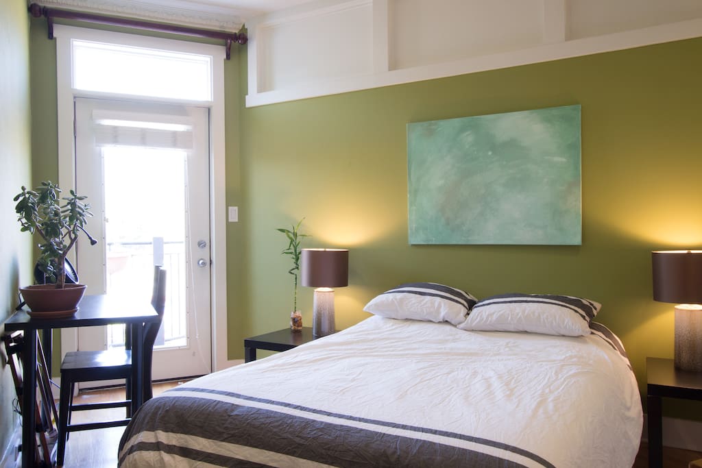Your bedroom with morning light, door to bottom level deck. Note shades can be closed on door.