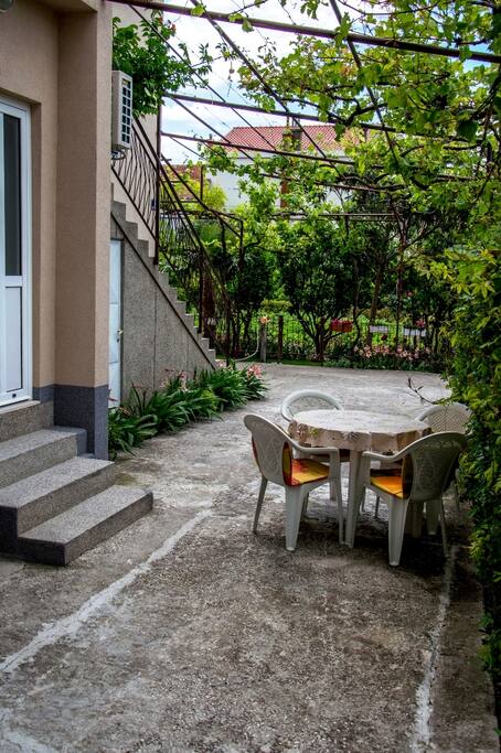 Outdoor table surrounded by flowers and greenery