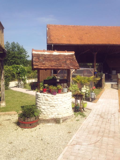 The walkway to the poolhouse passes by the well.