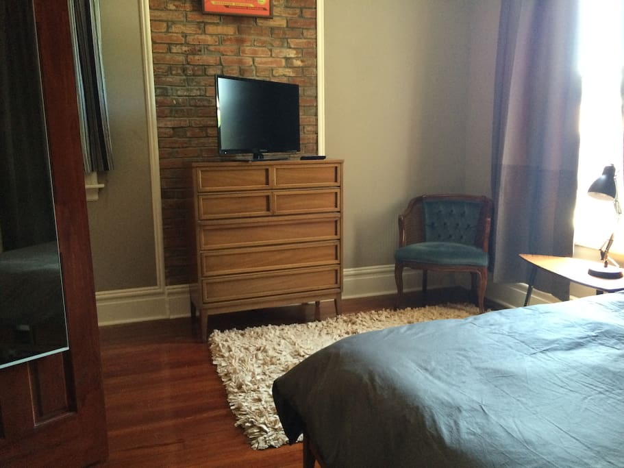 Bedroom with TV and plenty of storage space if needed. Black out curtains and blinds can keep the bedroom dark all day. A small balcony is located off the bedroom.