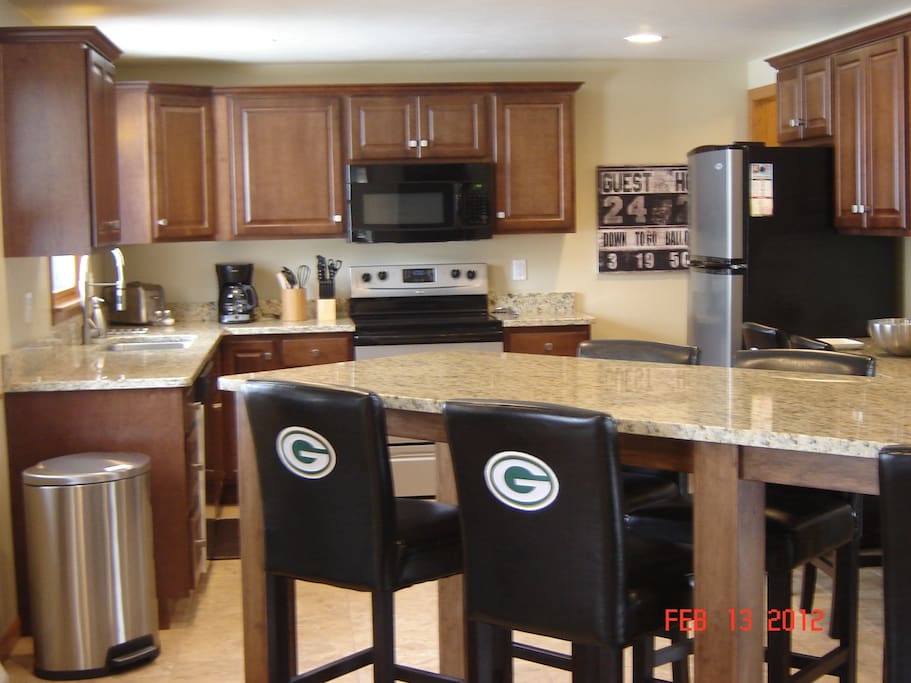 Large bar and view of the kitchen. House is all completely remodeled.