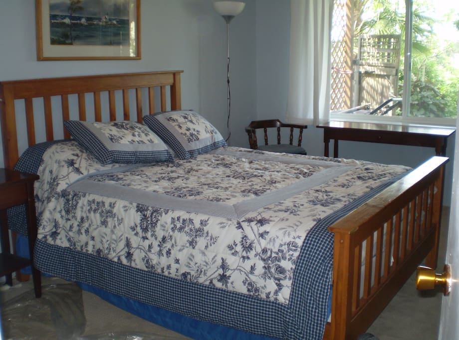 Generous bedroom with queen bed and view to Olympics
