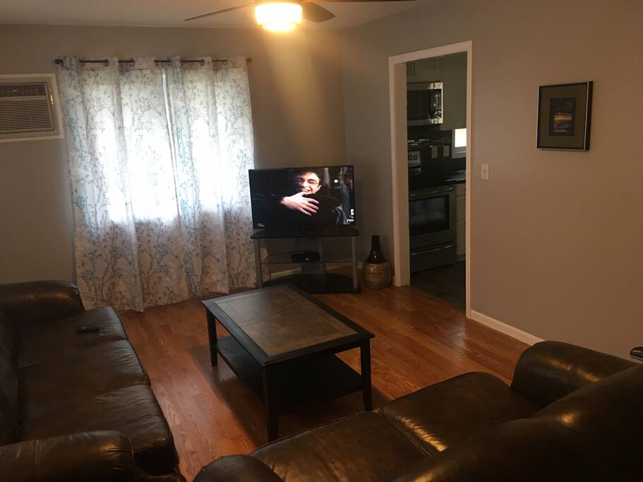 Living room w/ reclining couches and cable television