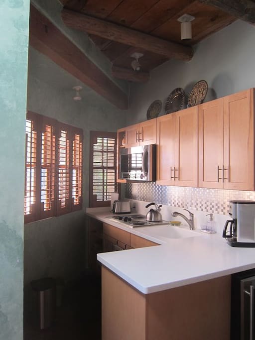 Kitchenette with microwave oven and small refrigerator and freezer