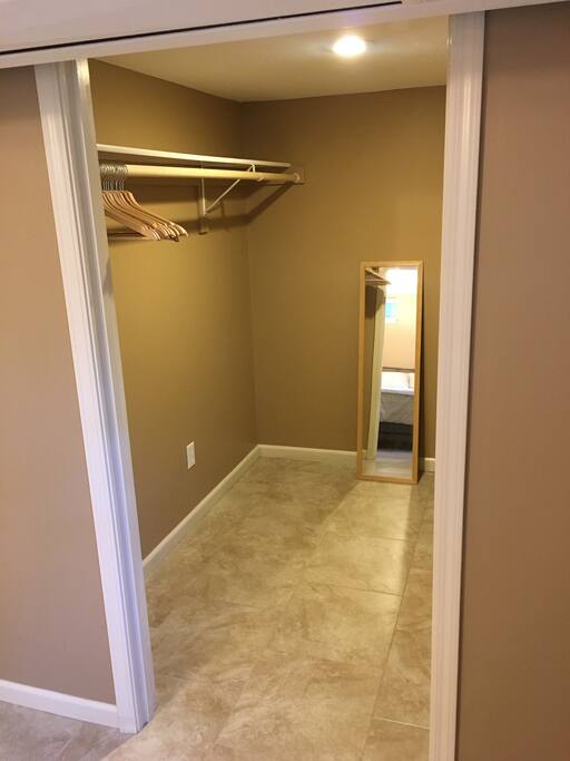 Large walk-in closet with hangers.