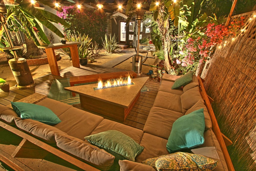 Our main outdoor deck with our home made furniture and fire-pit.