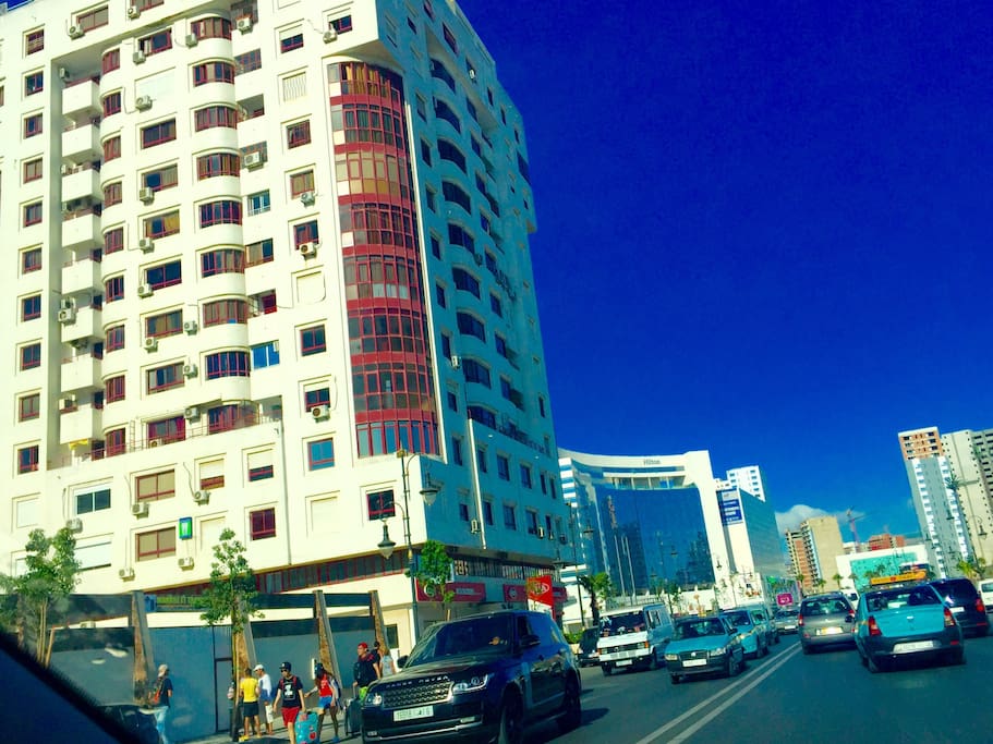The appartment is near the Hilton hotel and the main train station . The beach is right behind the building