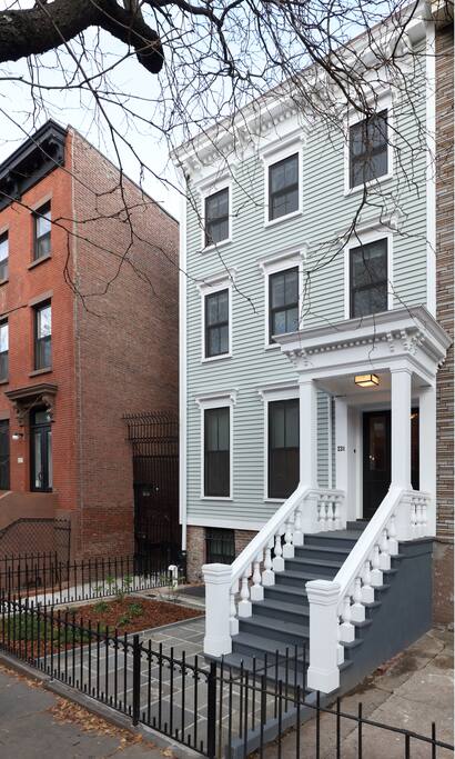 The front of the home, restored to the same look it had when originally built in 1850's. Great stoop for sitting and watching the world pass by.