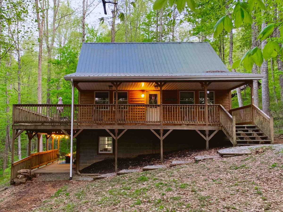 Exterior of the lake house rental with two decks and a staircase to the upper floor.