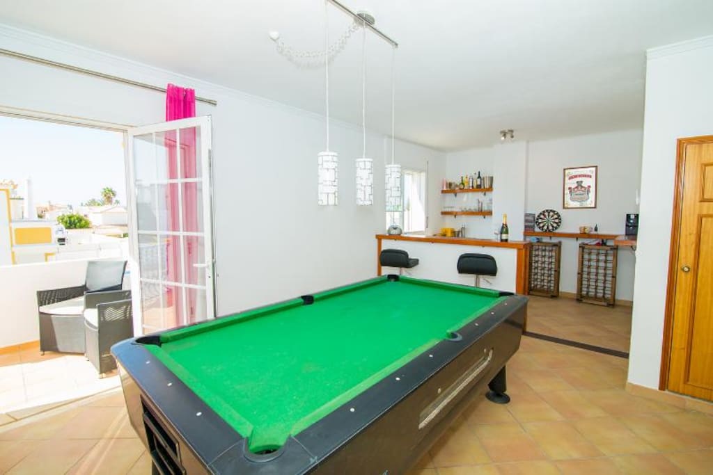 Bar area and pool table with balcony and sea views