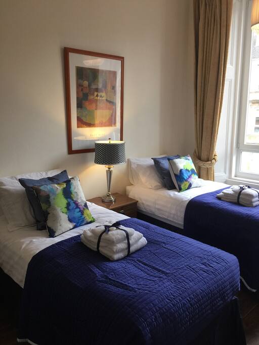 Front Bedroom with two single beds that at Guests request can be changed over to a super King Size Double Bed. The sun will rise and stream through in the morning.