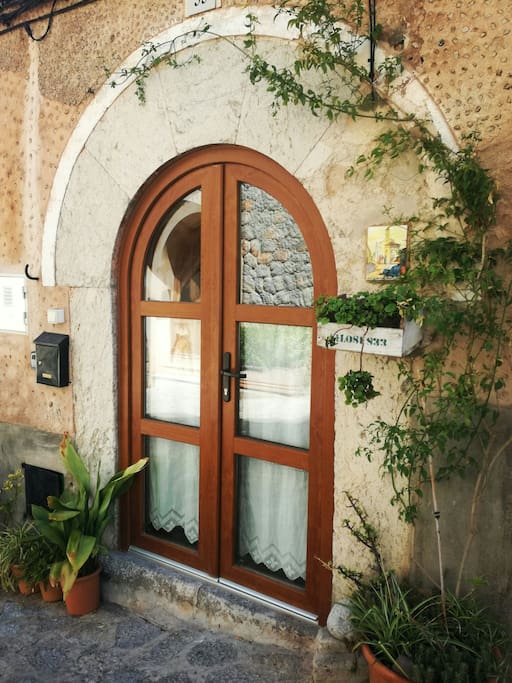 A typical front door with hand made lace curtains bought in the village