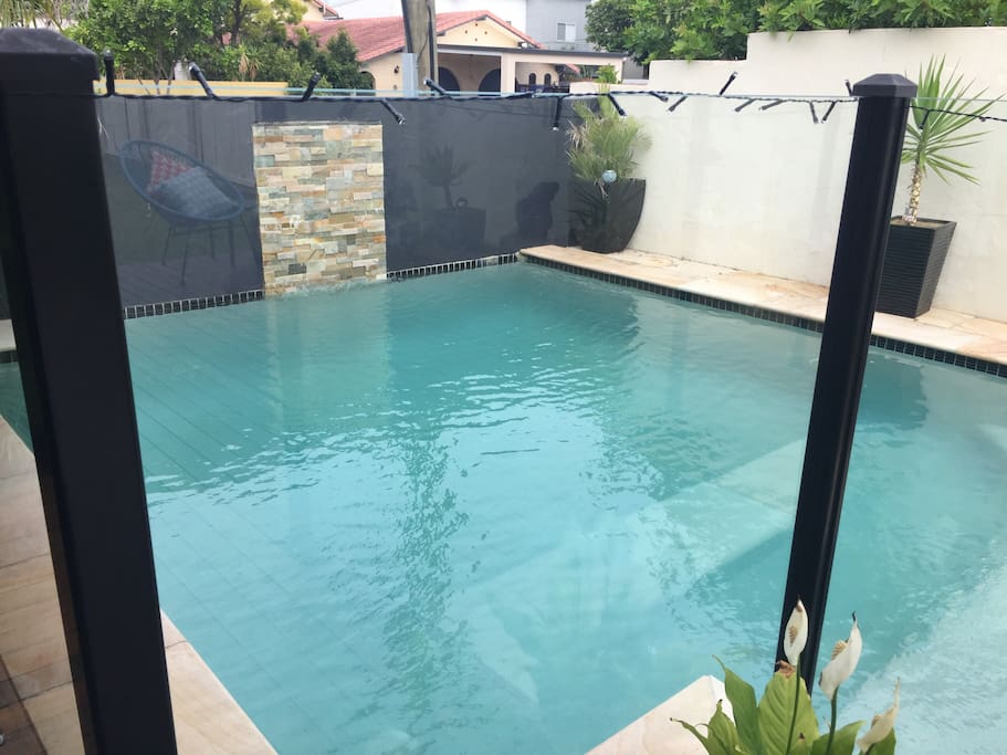 Beautiful fully fenced swimming pool with water feature, & LED light.