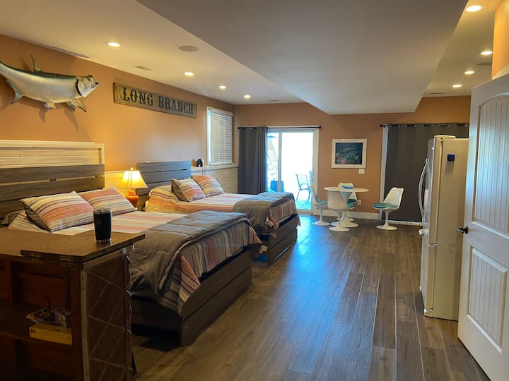 Fourth sleeping area in lower level, with two queen sized beds.   Full bath on this level with small kitchenette, complete with second fridge.  Closet and dresser.  Slider to patio area and views of Pine Lake.