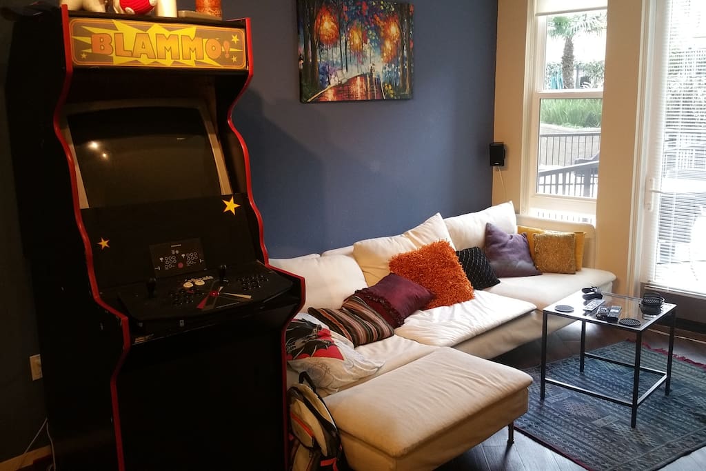 Homemade arcade and long couch.