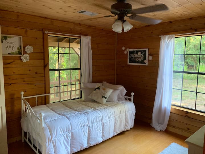 The Magnolia Room is the smaller of the two downstairs bedrooms (twin day bed with twin trundle bed).