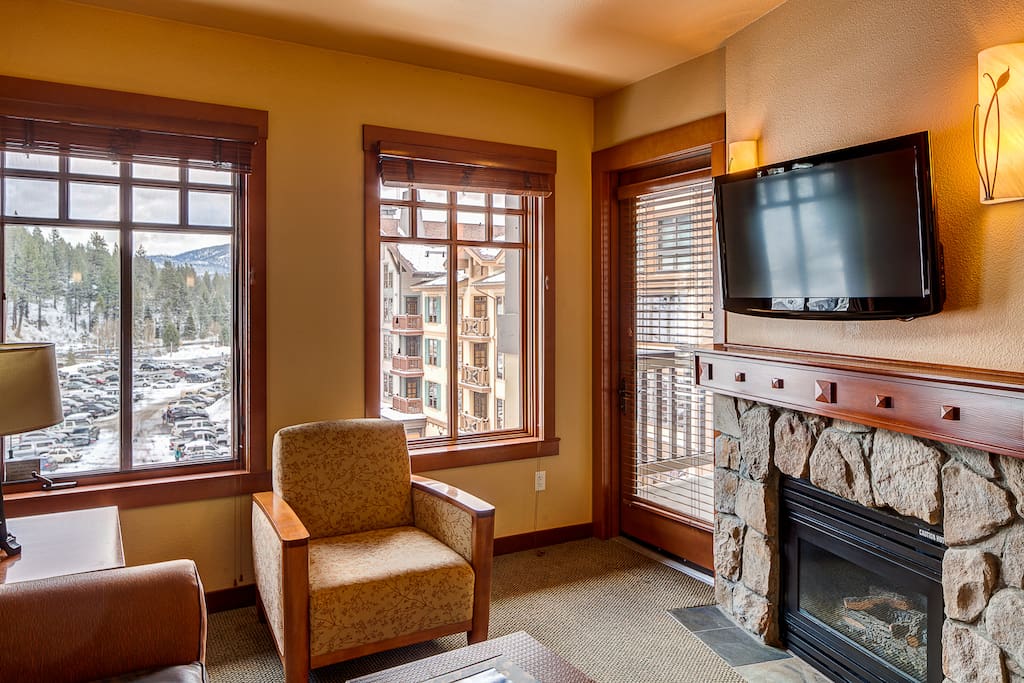 Instant-on gas fireplace with cable TV above. Door to view deck.