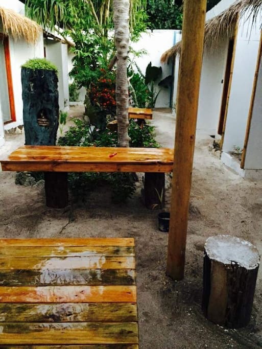 Wooden Comfortable Tables and Chairs Inside Guest House...