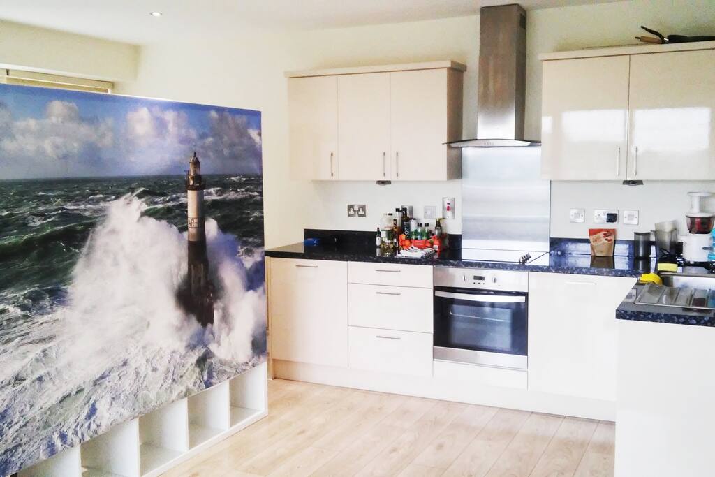 The fully-equiped American kitchen and the entrance of your open bedroom