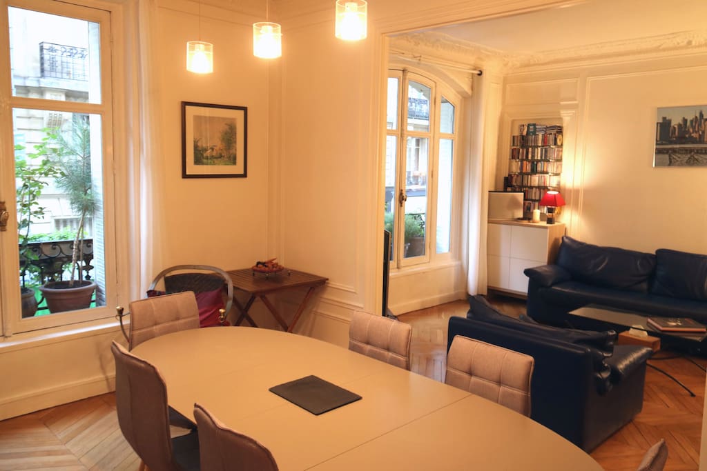 Sunny living and dining rooms facing beautiful XIXth century stone buildings