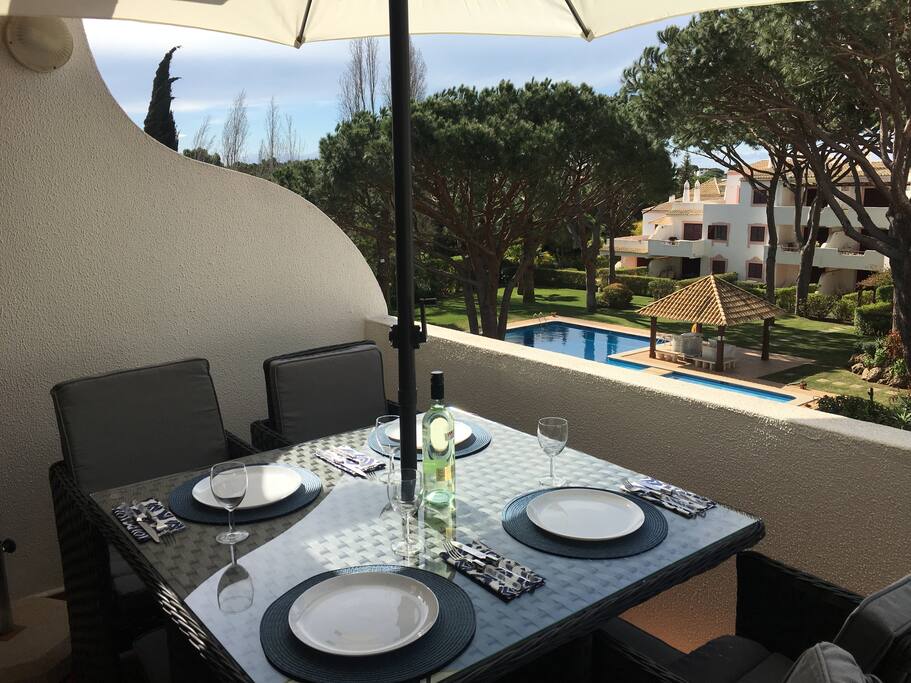 Dining on terrace overlooking pool