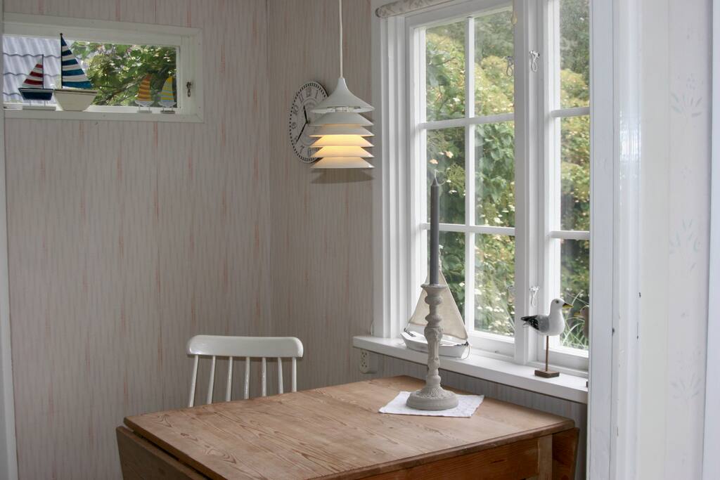 Breakfast table with a view of the garden and the large cabin.