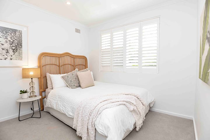 Indulge in the comfort of a queen bed with built-in cupboards, designed to cater to your storage needs during extended stays. Wake up to the beautiful morning light that fills the apartment, creating a warm and inviting atmosphere. 