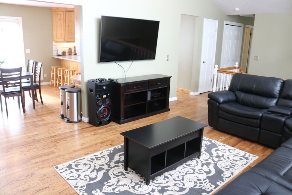 Listen to music, watch your favorite show on a 65" TV with Xfinity and lounge on this comfy leather couch big enough for a large group of people.