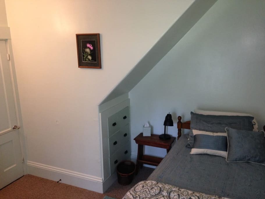 Guest room with built-in drawers. Robe hook and towel rack on back of door.
