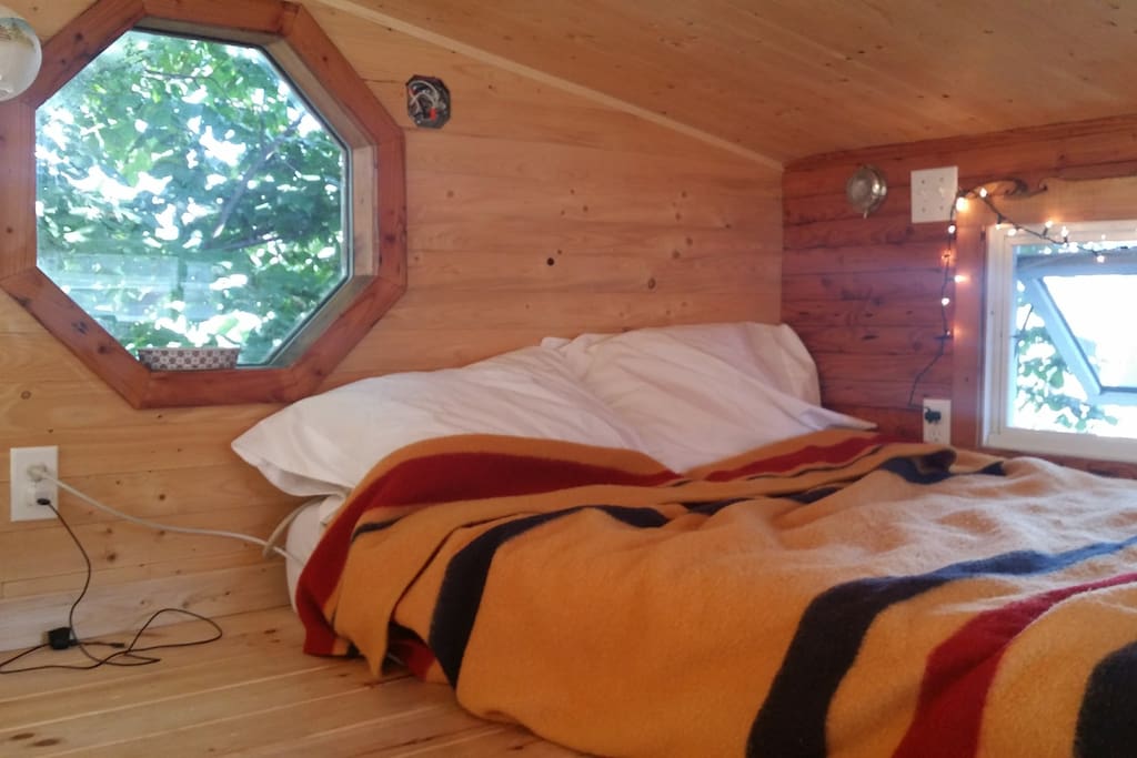 The sleeping loft has lots of headroom, as tiny houses go, and an outlet nearby to charge your devices.