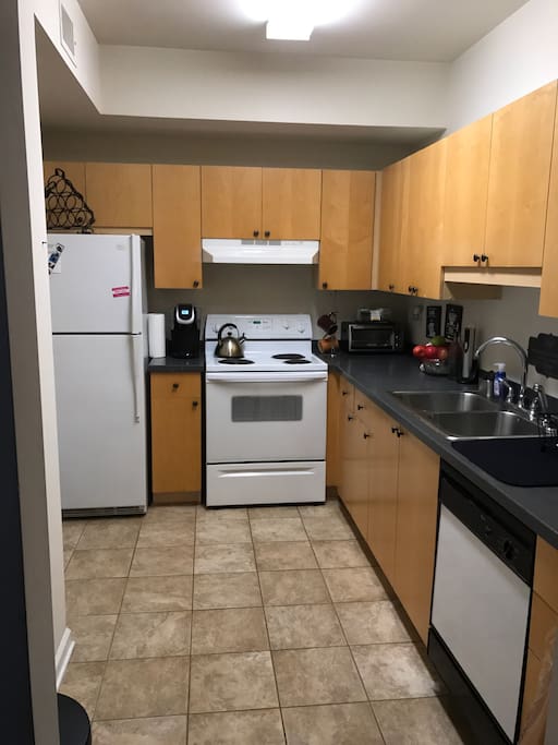 Spacious kitchen with pots and pans for you to prepare any meal. It's equipped with a Keurig, kettle, toaster oven and microwave.