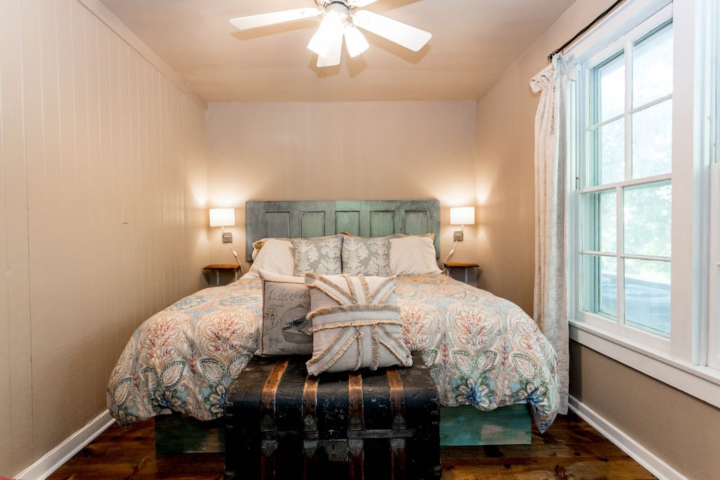 Gorgeous bedroom featuring a king size bed and reclaimed wood floors